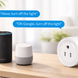 EvokLiving US smart plug plugged into outlet, compact design with on/off button and indicator light for home automation.