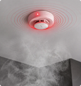 EvokLiving smoke detector mounted on ceiling, compact safety device with alert indicator and sensor for smoke detection.